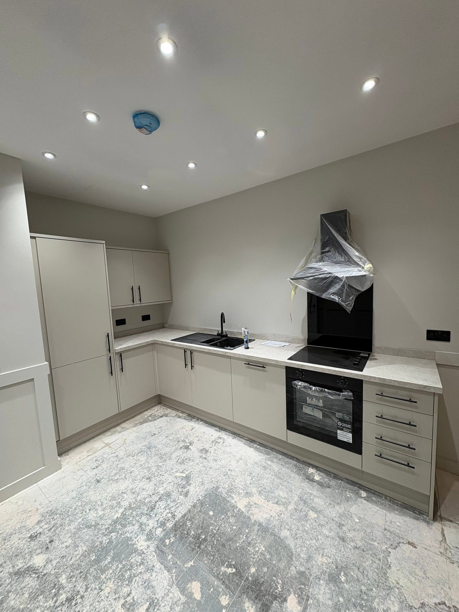 Grey and cream kitchen with black bar handles