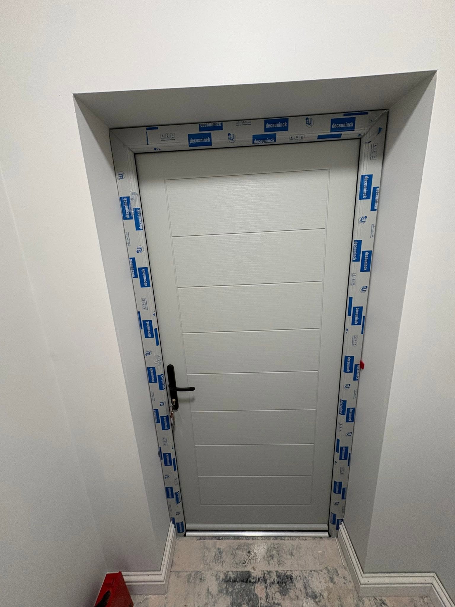 New white uPVC external door fitted in reveal